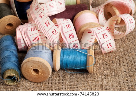 Old sewing items on canvas background