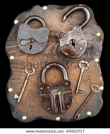Old locks and keys on wooden plank isolated on black. Clipping path included.