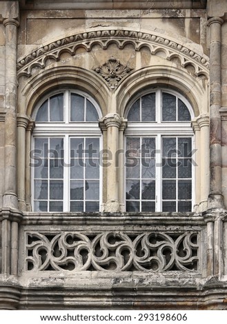 Worn double-Gothic castle window.