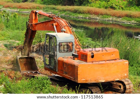 track-type loader excavator machine doing earth moving work at sand quarry