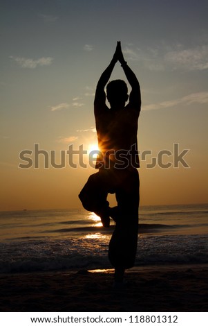 Silhouette of a beautiful Yoga man in the morning