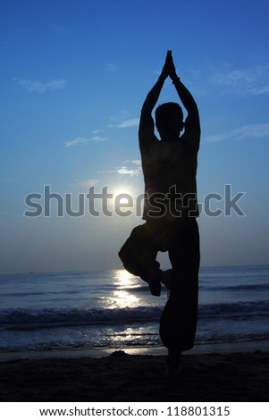 Silhouette of a beautiful Yoga man in the morning