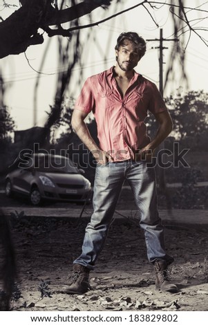 Handsome Indian male model in outdoor background.