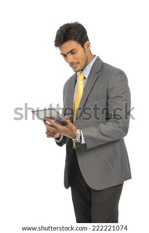 young businessman holding a tablet and watching screen