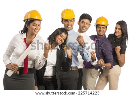 Happy group of Indian engineers standing against white background