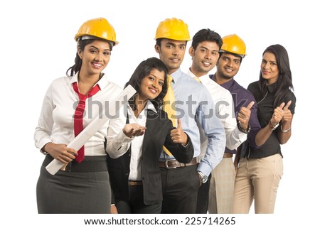 Happy group of Indian engineers standing against white background