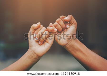 Hand to pinky swear,Happy couple or friendship holding hands together forever love concept.