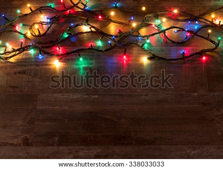 Christmas lights on wood texture with place for text
