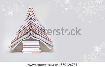 symbol Christmas tree from a colorful books on grey background. Empty copy space for your greetings