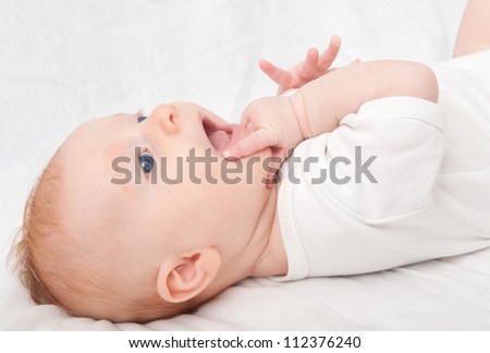 Newborn Baby Lying on Back on White Background