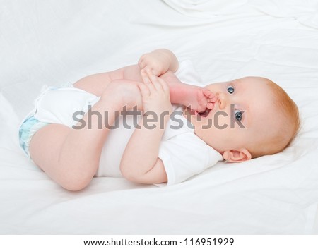 Cute Baby Girl Lying on Back on White Background