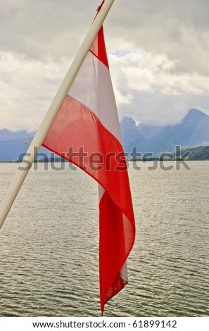 Alps under Cloudy Sky - View From Boat With Austrian Flag