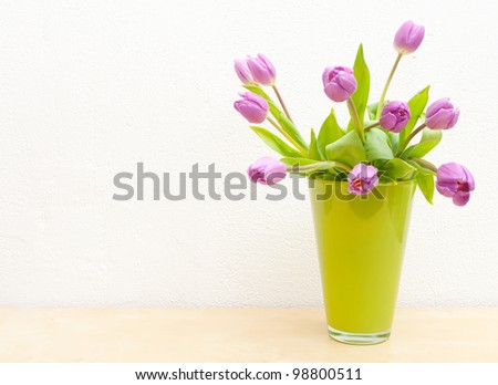 Pink Tulips Bouquet in Green Glass Vase on Wooden Table