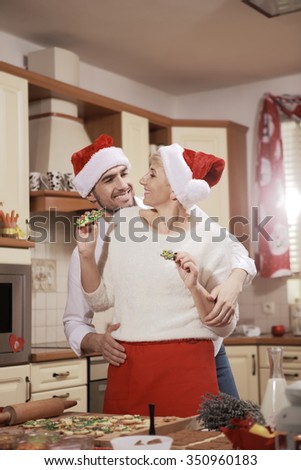 The man and woman in the kitchen nice to spend time in preparation for Christmas. Love. Joy. Happiness.