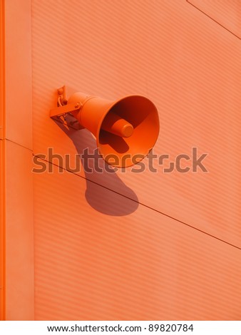 Loudspeaker on the wall of orange color