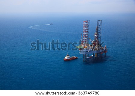 Aerial View of Offshore Jack Up Drilling Rig in The Middle of The Ocean:Selective focus with shallow depth field.