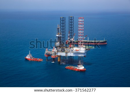 Aerial View of Offshore Jack Up Drilling Rig in The Middle of The Ocean:Selective focus with shallow depth field.