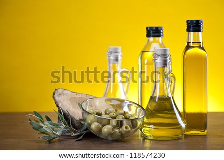 Fresh olives, olive oil on olive wood. Extra virgin