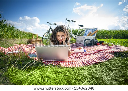 Women, picnic and computer! On grass in summer