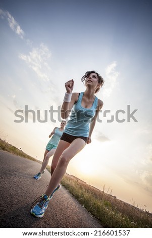 Two pretty girls jogging in the morning
