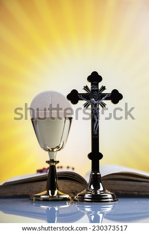 Christian religion, wine, bread and the word of God on yellow background