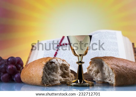 Christian religion, wine, bread and the word of God on yellow background