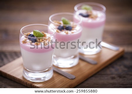 Delicious dessert with fruits and flakes on a wooden table. Studio shot