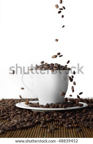 Filling the cup of coffee beans