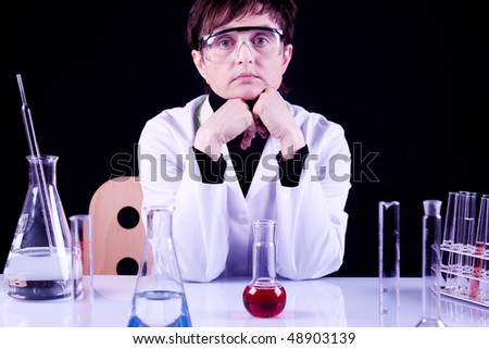 Female Scientist Portrait between flasks and fluids in lab