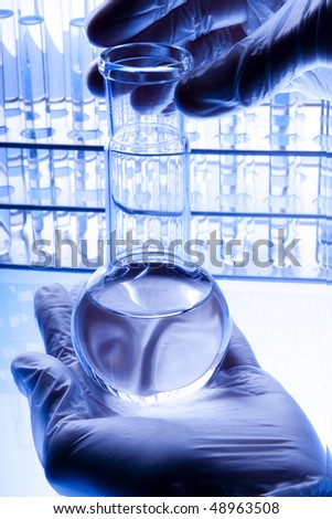Scientist holding flask with fluid