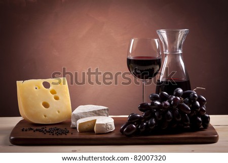 Cheese and wine composition on wooden table