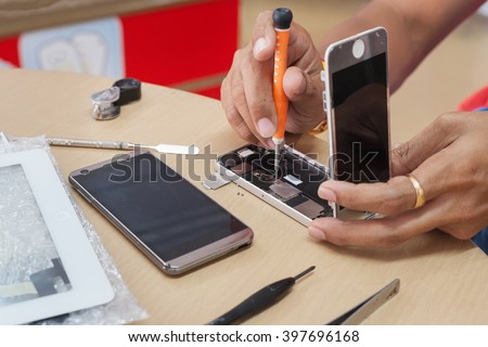 Close-up Photo Of Technician Hand Repairing Cellphone