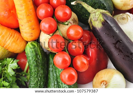 Fresh vegetables background with egg-plant, tomatoes, cucumber, potato, onion and carrot
