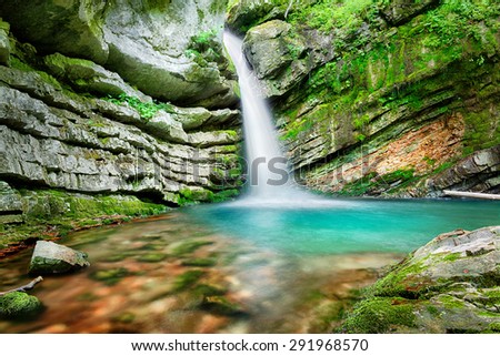 Beautiful waterfall surrounded by picturesque rocks and stones