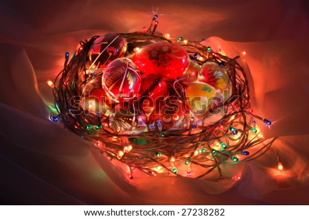 Easter basket made from bright garland containing painted eggs