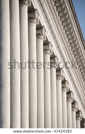 Line of white ionic columns with soft shadows