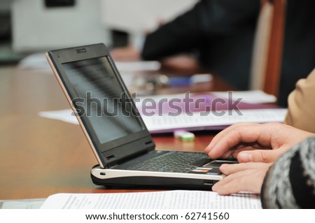 Business meeting or conference, focus on businessmans hands on the net-book