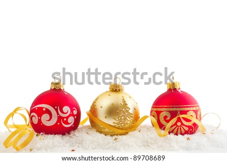Red and gold Christmas balls and snow isolated on white with copy-space for a text
