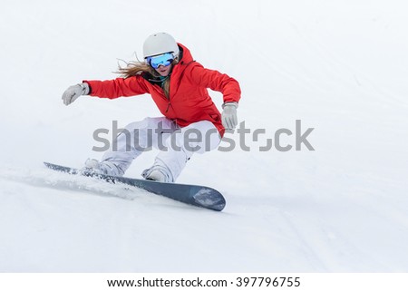 Woman snowboarder on the slopes frosty winter day. Beautiful girl on snoborde in the snow.