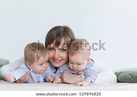 Mother holding on the hands twins baby