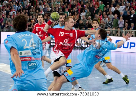 LJUBLJANA, SI - MARCH 9: Slovenian handball players (blue) play a match against Poland in qualification for handball ehf euro 2012 in Serbia on March 9, 2011 in Ljubljana, Slovenia.