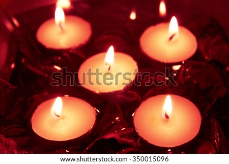Candle flame at night- 5 candles in a bowl with water and red dry flowers