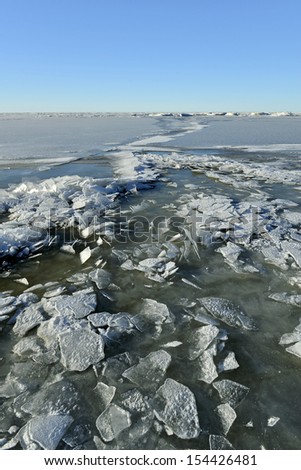 the frozen winter sea with ice blocks
