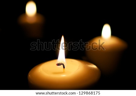 Three candles burn in the night