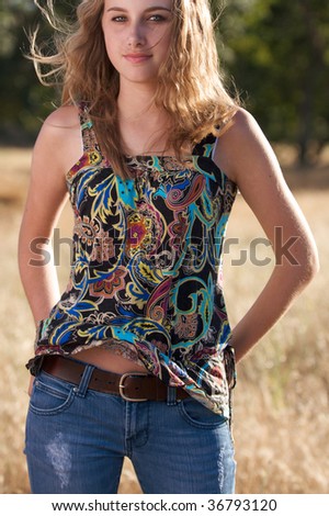 teenage girl in jeans and blouse outside