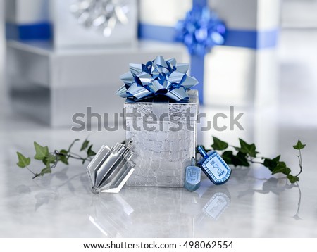 Beautiful silver and blue Chanukah gifts and dreidels for the Jewish holiday Hanukkah sit on  quartzite with copy space