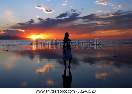 A woman gazing into an amazing sunset