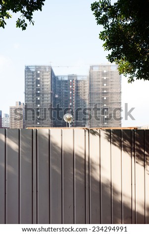 Urban High Rise Building Under Construction Behind Safety Barrier