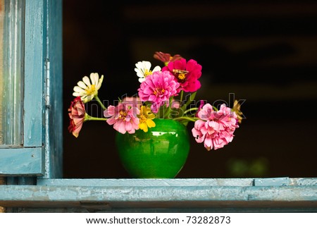 Colorful flowers in Chinese pottery on the old window