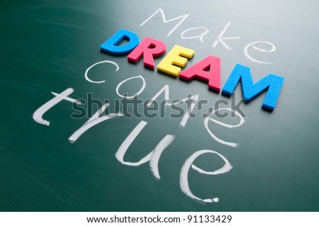 Make your dream come true. Colorful words on blackboard.